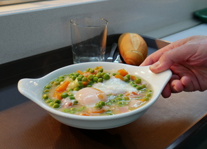 Pea, carrot, potato and leek stew with poached egg