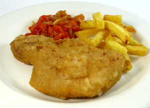 Breaded and pan fried pork chop with potatoes and red peppers stew