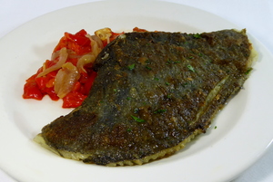 Grilled turbot with red peppers and onions stew
