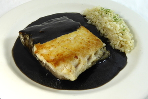 Hake in squid sauce with pilaw rice garnish