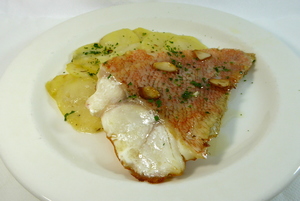 Roasted scorpion fish with baked potatoes and ‘bilbayne’ fried sauce
