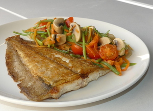 Grilled flatfish with sliced roast potatoes and sautéed organic vegetables