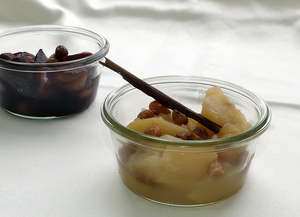 Apple and pear compote with white wine topped with raisins